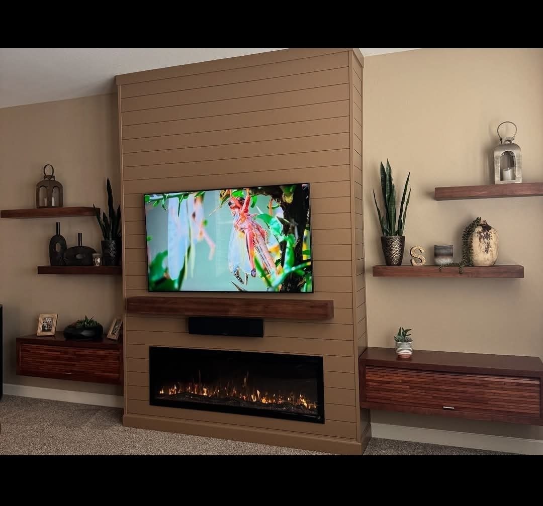 Tan shiplap media wall with dark wood floating shelves in Charlotte, NC by Fast Fix Charlotte
